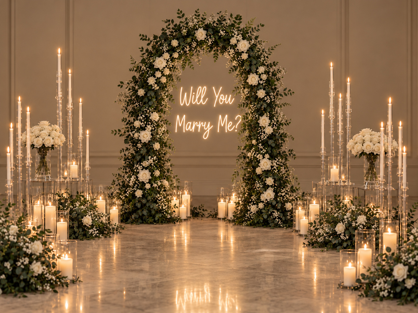 Luxury marriage proposal setup in Auckland featuring a lush oval arch with white roses and greenery, illuminated Will You Marry Me sign, clear acrylic candelabras, white rose arrangements and romantic LED candles.