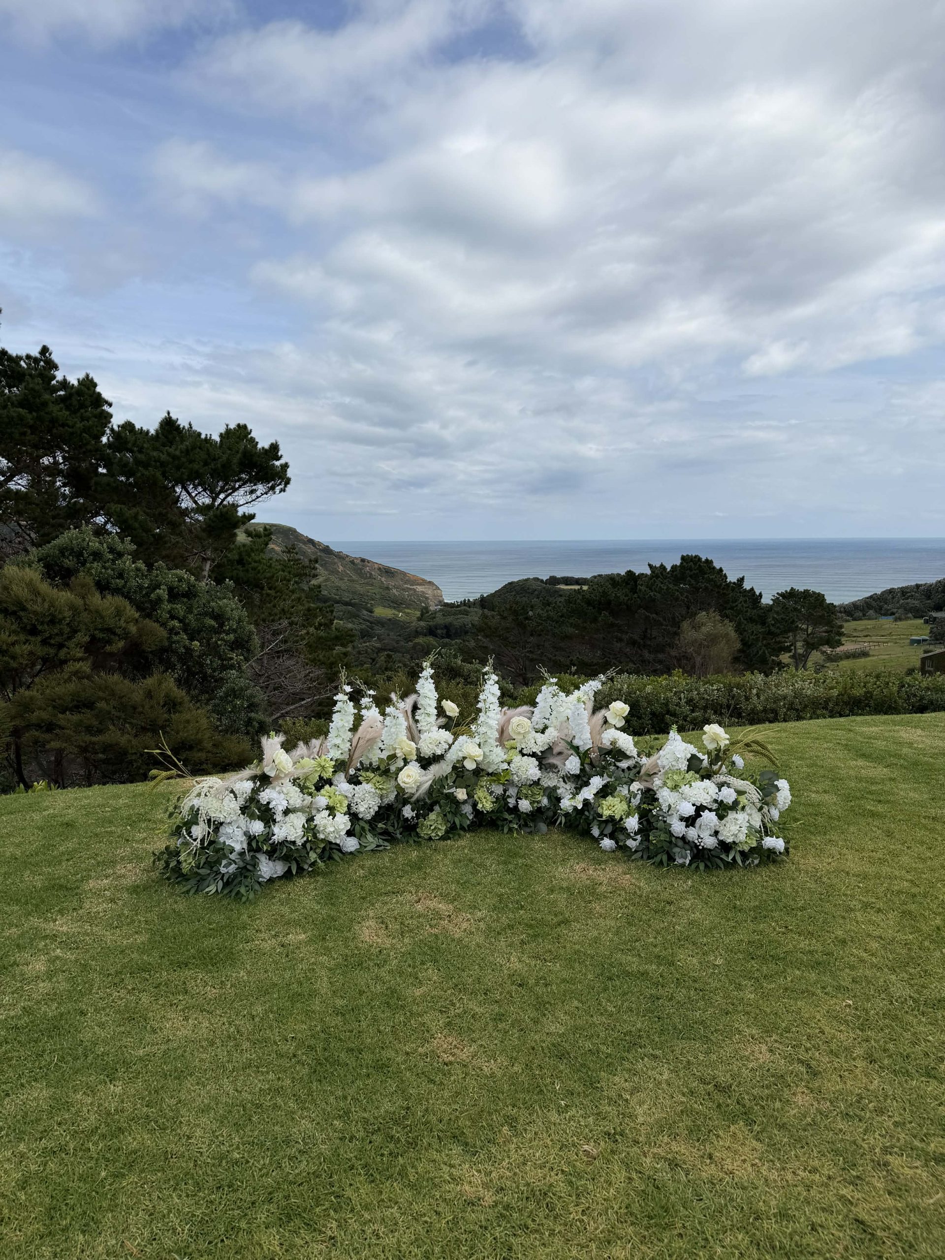 Low floral ceremony decor Auckland Wedding