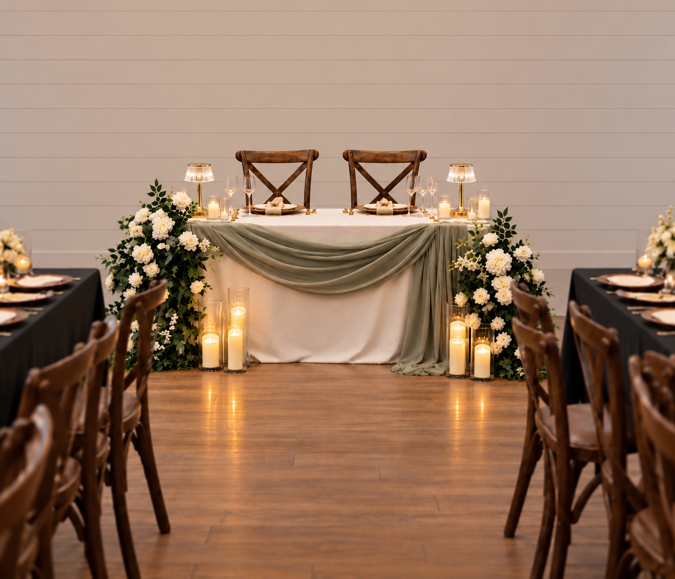 Sage green sweetheart table styling with white florals, greenery, gold LED lamps and candles for an Auckland wedding reception.